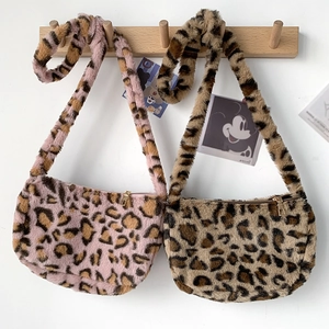 Close-up of pink and brown leopard print plush saddle bags with golden metal zippers
