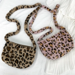 Close-up of leopard print plush crossbody bags in brown and lavender purple colors
