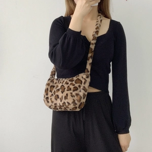 Detail of soft leopard print plush crossbody bag texture and faux fur material strap