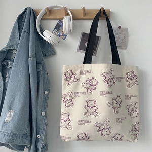 Minimalist beige canvas tote bag with cute purple cartoon bears and black handles