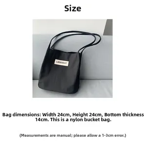 Size chart showing dimensions of black nylon water-resistant bucket bag with label