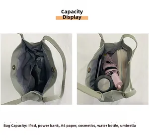 Internal view of green nylon tote bag showing spacious compartments and magnetic closure