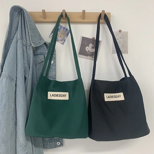 Waterproof nylon shoulder tote bag in green and black with Ladiesday woven label