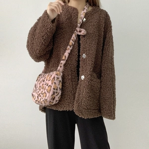 Detail of soft leopard print plush crossbody bag paired with a fuzzy brown coat
