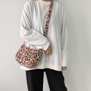 Detailed view of pink leopard print plush crossbody bag with soft faux fur texture