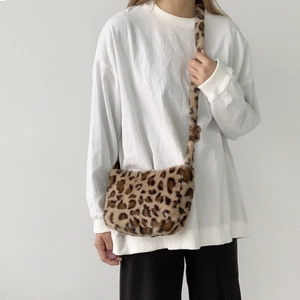 Detail showing the fluffy leopard print faux fur texture of the crossbody bag