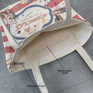 Canvas tote bag interior detail showing metal zipper and mobile phone inner pocket