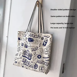Large off-white canvas tote bag featuring blue music icons and 16-inch laptop storage