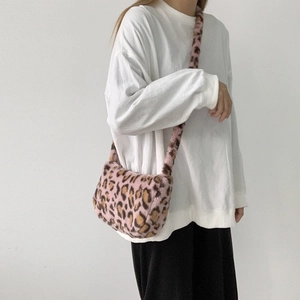 Detail of pink leopard print plush crossbody bag with soft faux fur and long strap