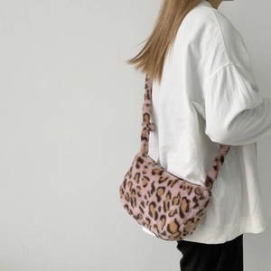 Detailed close-up of pink leopard print faux fur shoulder bag with soft plush texture