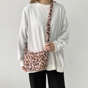 Close-up of pink leopard print plush crossbody bag showing soft faux fur texture