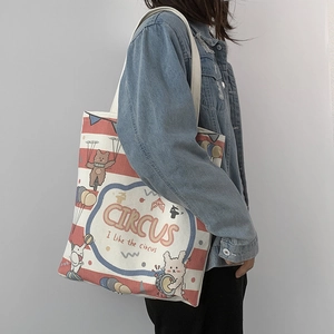 Side view of a large canvas tote bag with red stripes and circus animal illustrations