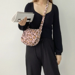 Close-up of pink leopard print plush crossbody bag with soft faux fur texture detail