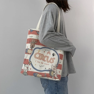 Close-up of canvas tote bag featuring red stripes and circus animal illustrations