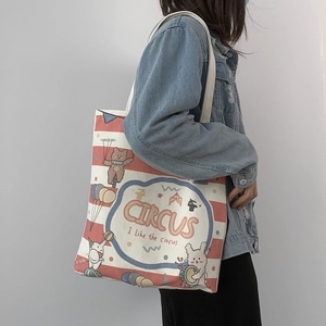 Side view of circus animal print canvas tote bag with red and white horizontal stripes