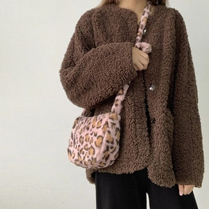 Close-up of soft pink leopard print plush shoulder bag texture and furry strap detail