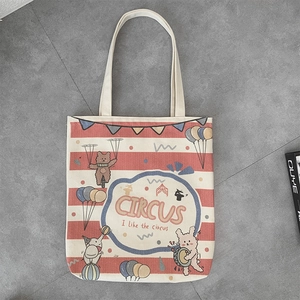 Detail of canvas tote bag featuring circus illustrations of bear, elephant and rabbit