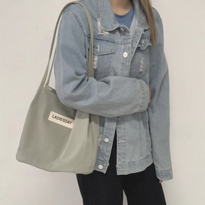 Detailed side view of water-resistant green nylon tote bag with LADIESDAY logo