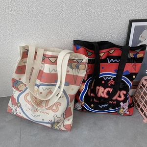 Detail view of large canvas tote bag featuring circus bunny illustration and red stripes