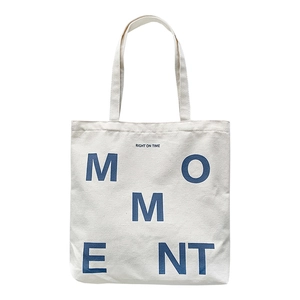 Minimalist cream canvas tote bag with MOMENT lettering print for women daily use