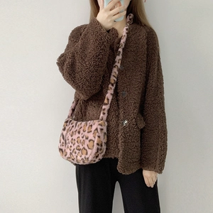 Detail of pink leopard print plush crossbody bag paired with brown fleece cardigan jacket