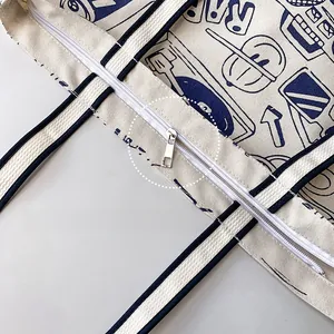 Close-up of premium metal zipper puller and durable stitching on canvas tote bag