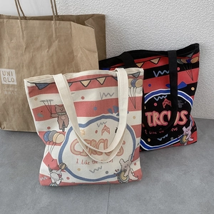 Detail of striped canvas tote bags with circus cartoon prints and wide handles