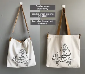 Detail of white canvas tote bag showing versatile crossbody and handbag carrying methods