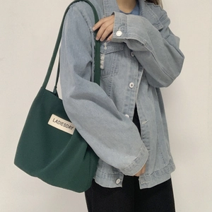 Detail of dark green water-resistant nylon tote bag with white Ladiesday label patch