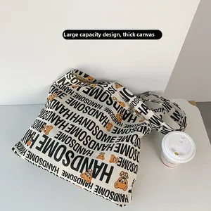 Detail view of large canvas tote bag with Handsome text and cute bear patterns