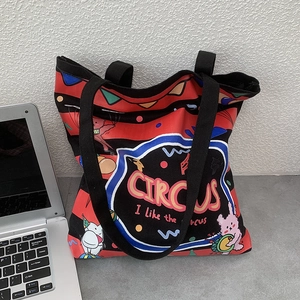 Detail of canvas tote bag featuring red and black stripes with circus rabbit illustration