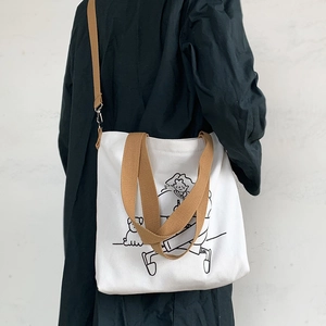 Japanese style canvas tote bag with cute cartoon illustration and adjustable brown straps