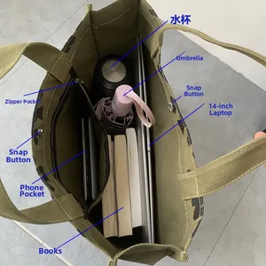 Interior view of army green canvas tote bag showing large capacity and zipper pocket