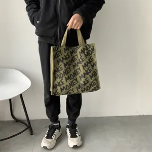 Army green canvas tote bag with black Make Money print for daily shopping and books