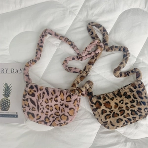 Detailed view of plush leopard print crossbody bags in pink-purple and classic brown faux fur