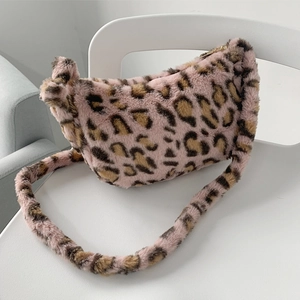 Close-up of soft pink leopard print faux fur texture and metal zipper on crossbody bag
