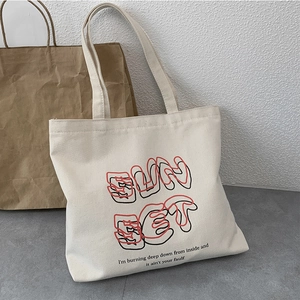 Minimalist white canvas tote bag with SunSet artistic text and red graphic print