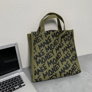 Detail of army green canvas tote bag with black Make Money print and sturdy handles