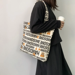 Detail of canvas tote bag with black handsome text and cartoon bear print