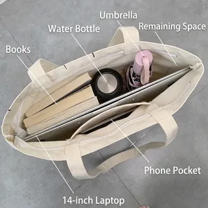 Large beige canvas tote bag showing interior storage capacity for a 14-inch laptop and books