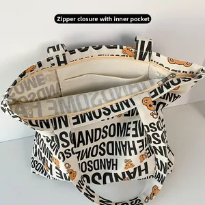 Detail of canvas tote bag showing top zipper closure and interior slip pocket