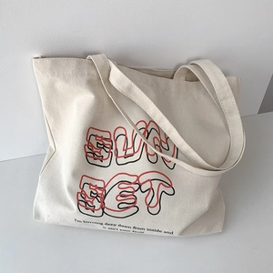 Close-up of Sunset art print on off-white canvas tote bag with poetic text detail