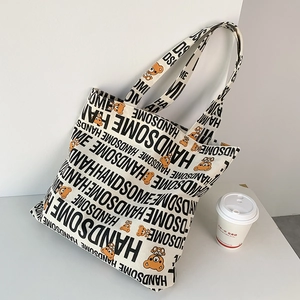 Detail of canvas tote bag featuring handsome bear print and spacious interior design