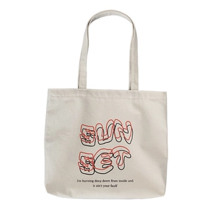 Minimalist off-white canvas tote bag featuring SUN SET artistic font and red-black typography