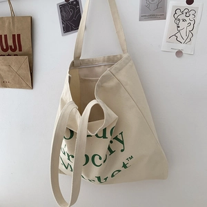 Detail view of the interior slip pocket inside the beige canvas grocery market tote bag