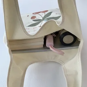 Top view of spacious canvas tote bag showing interior capacity for books and umbrella