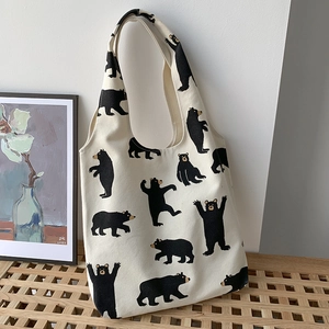Detail of canvas tote bag texture with cute black bear prints in a minimalist room