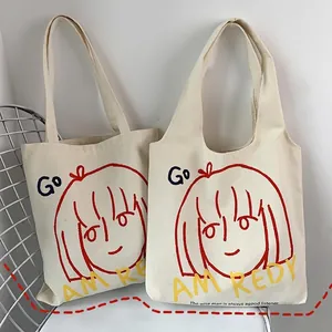 Artistic canvas tote bag with girl illustration and typography on a white mesh chair