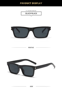 Detail of square black sunglasses with silver metal hinge accents and dark lenses