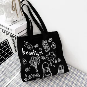 Borsa tote in tela nera con graffiti artistici e stampa bianca di rose e cuori